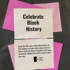 Pink and white poster that says, "Celebrate Black History" with a QR code